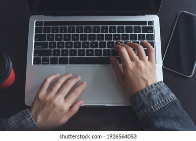 Internet Network Technology, Online Working, E-learning Concept. Woman Hands Working, Typing On Laptop Computer Keyboard With Blank Black Screen Mobile Phone And Cup Of Coffee On Dark Table, Top View