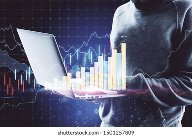 Internet security concept with hacker using laptop and digital financial graphs and diagram.Double exposure.