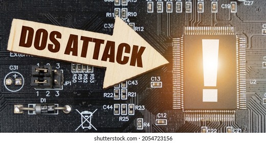 Internet And Security Concept. On The Computer Board, A Microcircuit With An Exclamation Mark And An Arrow With The Inscription - DoS Attack