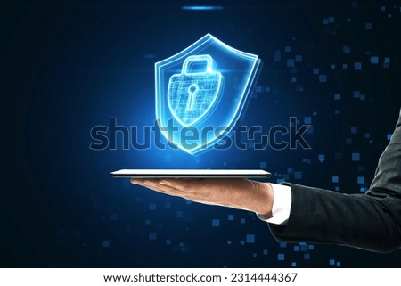 Internet security, cyber access protection and online safety concept with keyhole inside closed padlock and shield hologram above businessman hand with digital tablet on abstract dark pixel background