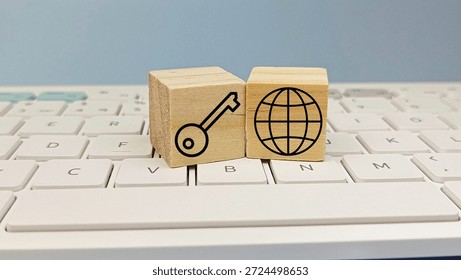 Internet Security and Global Network Access Concept with Key and Globe Icons on Wooden Blocks on Computer Keyboard. 