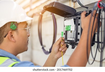 An Internet Technician Is Repairing Or Maintaining A Fiber Optic Connection By Opening A Fiber Optic Connector.