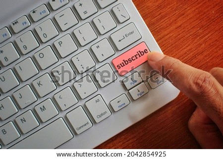 Internet and technology concept. Finger pressing keyboard label with SUBSCRIBE.