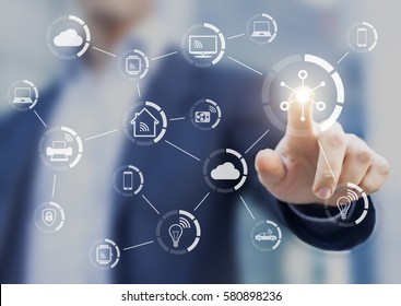 Internet of things (IOT) concept with a network of connected objects exchanging data with wireless connection, person touching virtual screen, smart home - Powered by Shutterstock