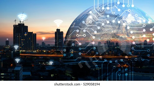 Internet Of Things , Iot , Smart Home , Smart City And Network Connect Concept. Human Hand Holding White Phone And Iot Icon With City Sunset View And Earth Furnished By NASA. Background And Wifi Icons