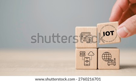 Internet of Things IoT technology concept with wooden blocks showing connected devices, cloud computing and digital network. Smart home systems, data communication and modern business innovation.