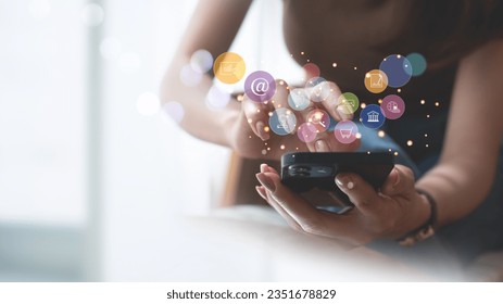 Internet of Things (IoT) technology, Woman using mobile smartphone with E-commerce technology icon on virtual global internet network, Global business, Social media, digital marketing concept.