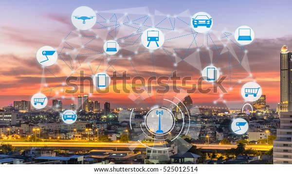 Internet of Things and\
Smart city concept. Smart things icons mesh on city traffic at\
twilight background.