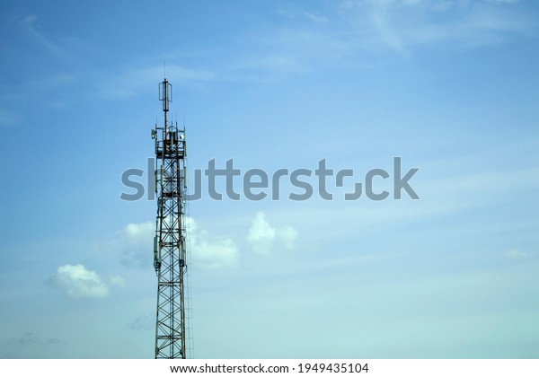 Internet tower against\
the blue sky. Telecommunication tower with TV transmitter.\
Communication tower.