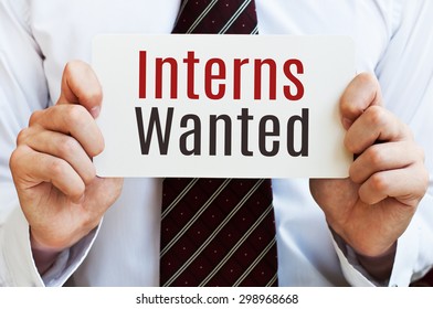 Interns Wanted Card In Hands