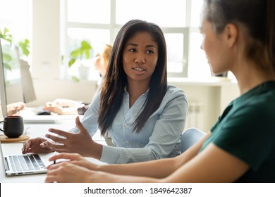 Internship. Attentive focused mixed race woman mentor trainer sitting by laptop at workplace explaining telling young caucasian female new hired employee trainee intern principles of corporate working - Shutterstock ID 1849642387