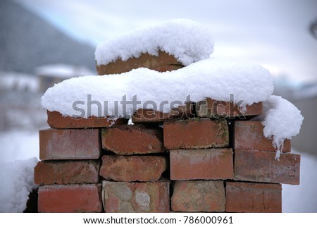 Interposed bricks covered with snow