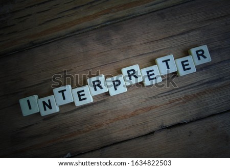 Interpreter, word cube with background.