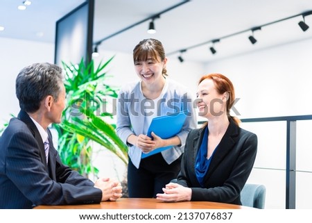 Interpreters and secretaries working in an office Сток-фото © 