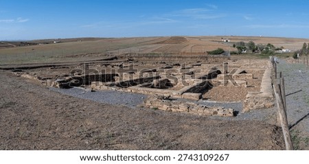 Interpretive sign 'Edificio Comercial' with reconstruction for the Roman commercial building at Contributa Iulia Ugultunia, Extremadura, Spain.