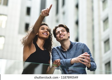 Interracial business couple have a conversation in modern city. - Powered by Shutterstock