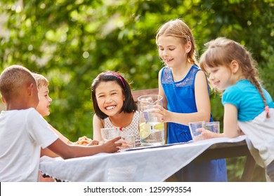 Interracial Children Celebrate Kids Party With Friends Drinking Water