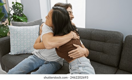 Interracial couple embracing happily in a cozy living room, reflecting love, diversity, and family in a home setting. - Powered by Shutterstock