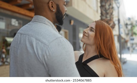 Interracial couple embracing outdoors in an urban street, showcasing love and connection between a man and a woman in a lighthearted relationship. - Powered by Shutterstock