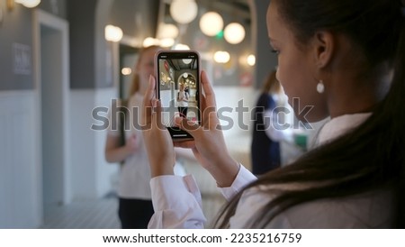 interracial couple or friends recording trendy dance moves for social media account in high school. African-American teen girl take video of classmate dancing in school corridor