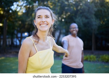 Interracial, couple holding hands and park with happiness, romance and bonding outdoor, love or relationship. Romantic, woman and black man in nature, joyful or touching hand on date and quality time - Powered by Shutterstock