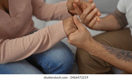 Interracial couple holding hands in a symbol of love and togetherness, showcasing diversity and affection. - Powered by Shutterstock