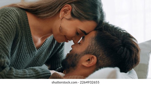 Interracial, couple, love and kiss being happy, bonding and embrace for communication, talking together and at home. Romantic, man and woman with smile, intimate and being loving for romance or hug