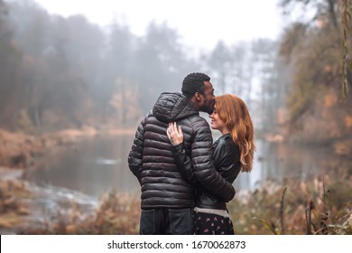 Interracial Couple Posing In Autumn Leaves Background, Black Man And White Redhead Woman