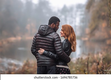 Interracial Couple Posing In Autumn Leaves Background, Black Man And White Redhead Woman