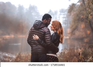 Interracial Couple Posing In Autumn Leaves Background, Black Man And White Redhead Woman