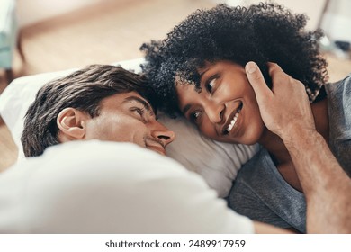 Interracial couple, relax and love on bed in morning for care, support and respect in apartment. Happy, man and woman together in home for date, cuddle and marriage or anniversary on weekend - Powered by Shutterstock