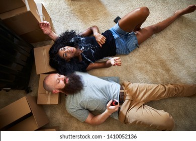 Interracial Couple Relaxing After Hard Work Moving By Smoking Marijuana Joint Together While Laying On Floor