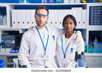 Interracial Couple Working At Scientist Laboratory Thinking Attitude And Sober Expression Looking Self Confident 