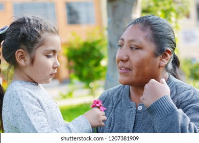 Interracial Family. Native American Woman With Her Little Latin Daughter In The Park.