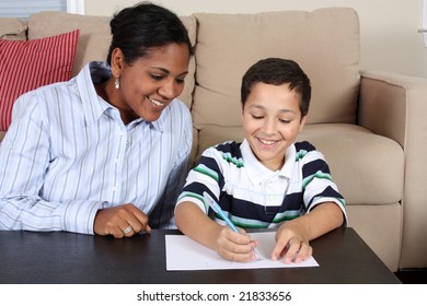 Interracial family sitting together writing paper