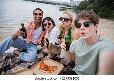 Interracial Friends In Sunglasses Holding Beer Near Tasty Pizza On Beach