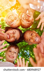 Interracial Kindergarten Group Putting Heads Together In Circle As Motivation