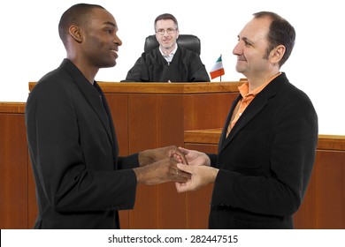 Interracial Male Gay Couple Celebrating Legalization Of Same-sex Marriage In Ireland.  The Court Bench Has A Judge And An Irish Flag.