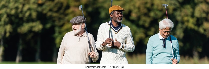 Interracial Senior Friends Walking With Golf Clubs Outside, Banner