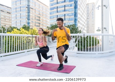 Interracial sportive couple training outdoors - Multiracial couple wearing sportswear and doing functional workout outdoors to strenght body muscles, core abs, stamina and cardio