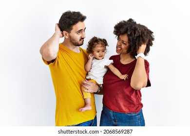 Interracial Young Family Of Black Mother And Hispanic Father With Daughter Confuse And Wondering About Question. Uncertain With Doubt, Thinking With Hand On Head. Pensive Concept. 