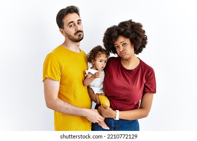 Interracial Young Family Of Black Mother And Hispanic Father With Daughter Looking Sleepy And Tired, Exhausted For Fatigue And Hangover, Lazy Eyes In The Morning. 