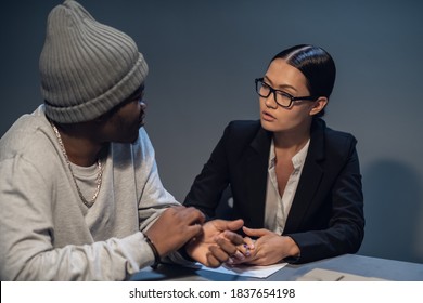 In The Interrogation Room, A Suspect In A Drug Distribution And Possession Case Consults With A Public Defender.