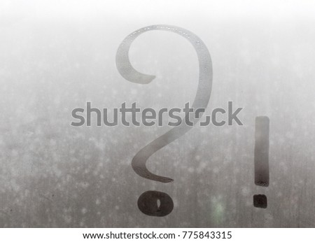 Interrogatory and exclamation marks written on the misted glass.