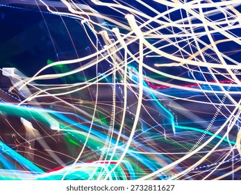 Intersecting and intertwining light streaks in white, blue, green, and red hues generating a dynamic visual representation of energy, movement, and technology against a dark background