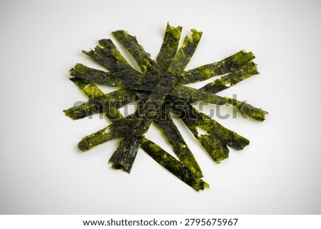 Intersecting Shredded Strips of Crispy Roasted Seaweed Nori Isolated on White Background