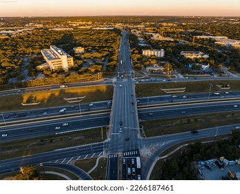 intersection bridge over Highway during golden hour sunrise  aerial drone sunrise over busy road way in Austin , Texas , USA