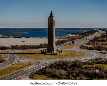Intersection with two roads and clock tower near ocean