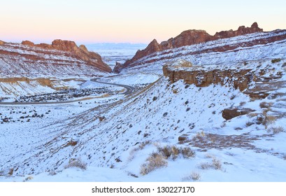 Interstate 70 winds it's way through snow covered Spotted Wolf Canyon through the San Rafael Reef in Utah in Winter