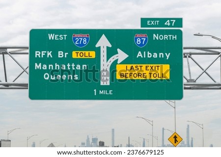 Interstate and directional signs to I-278 West RFK Bridge, Manhattan, Queens and I-87 North Albany, last exit before toll  exit 47 in direction of New York City, NY, USA, skyline vague in background